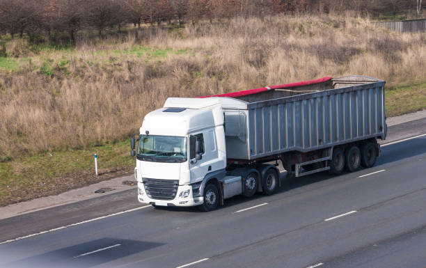 istock White lorry with tipping trailer in motion on the motorway 641348400