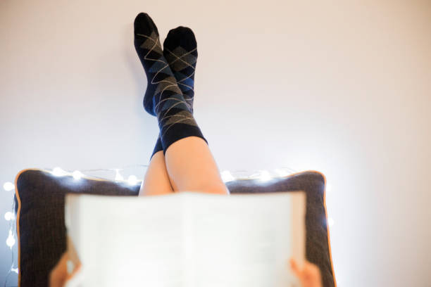 istock Close up of Woman lying in bed while reading  book 641349426