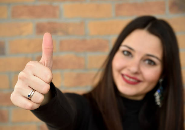 istock Beautiful young woman with thumb up 641350602