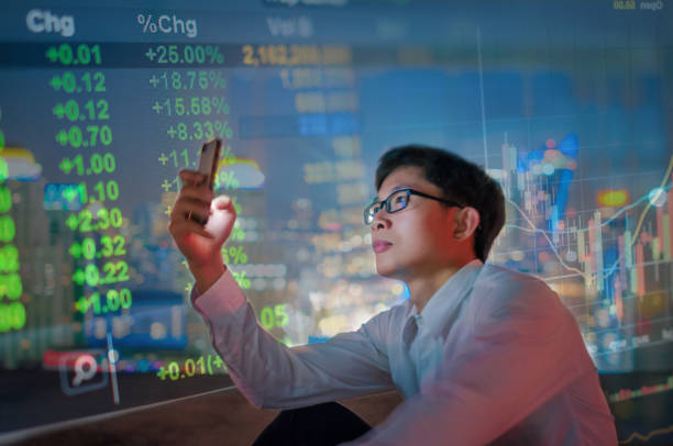 istock Young business man using smart phone analysis stockmarket 641354016