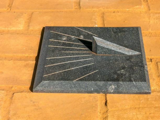 istock Granite Sundial - sun clock on orange brick floor 641354446