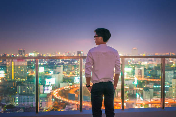 istock Young business man at night cityscape background 641355280