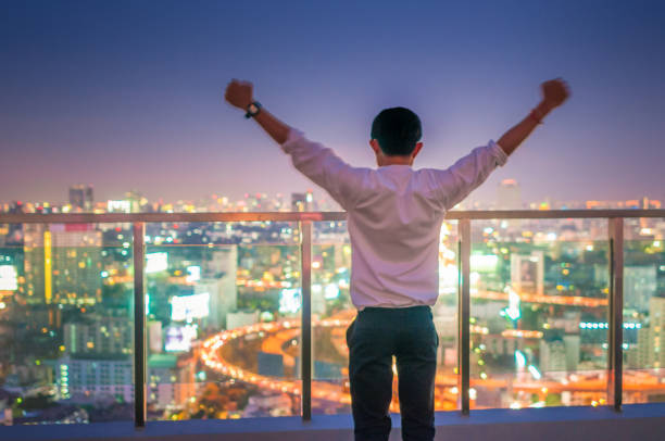 istock Young business man at night cityscape background 641355292