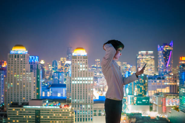 istock Young business man using laptop and digital tablet cityscape background 641355314