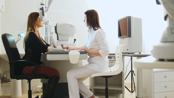 istock Modern ophthalmologist examining attractive woman's eyes with modern equipment 641356820