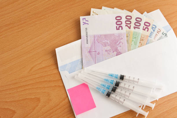 Syringes and banknotes EURO stock photo