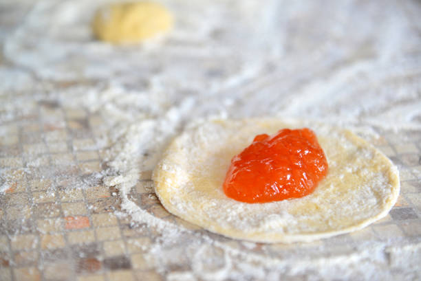 Apricot jam on dough for preparation of pies