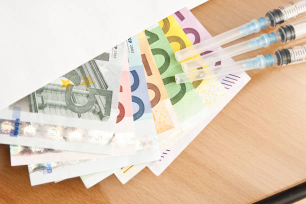 istock Euro syringes and banknotes 641358148