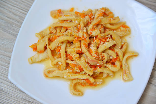 Calamaries stewed in cream sauce with carrots