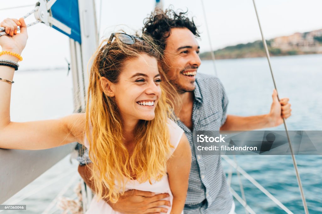 Couple sailing on a yacht Couple enjoying their time together on a yacht. Couple - Relationship Stock Photo