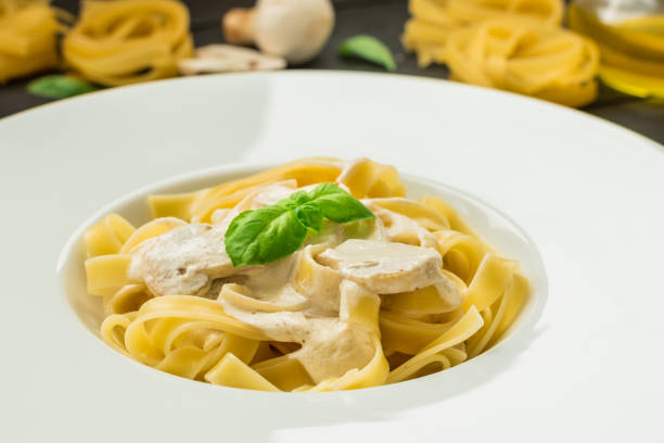 istock Delicious fresh pasta with cream sauce and mushrooms 641363384