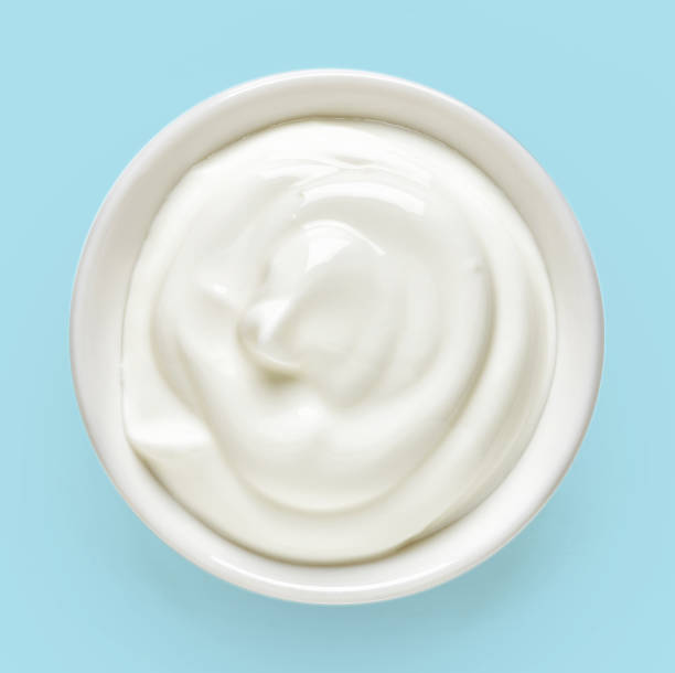 istock Bowl of cream on blue background, from above 641364404