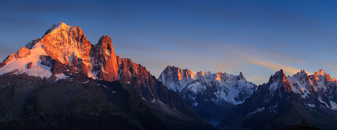 Panorama of the Alps near Chamonix, with Aiguille Verte, Les Drus, Auguille du Midi and Mont Blanc, during sunset.