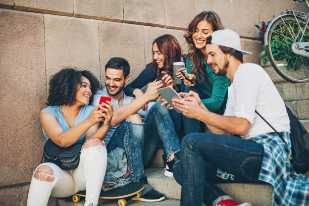 istock Multi-ethnic group of teens texting outdoors 641370460
