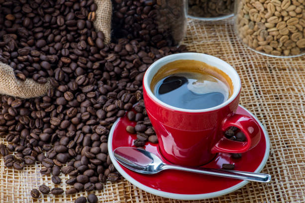 Cup of coffee on coffee beans background stock photo