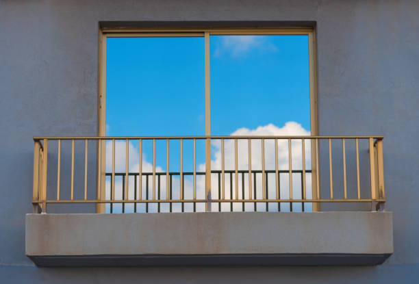 Cloud and blue sky mirroring in Window with balcony