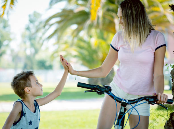 istock Mother and son 'high five' stay with rented bicycles 641375960