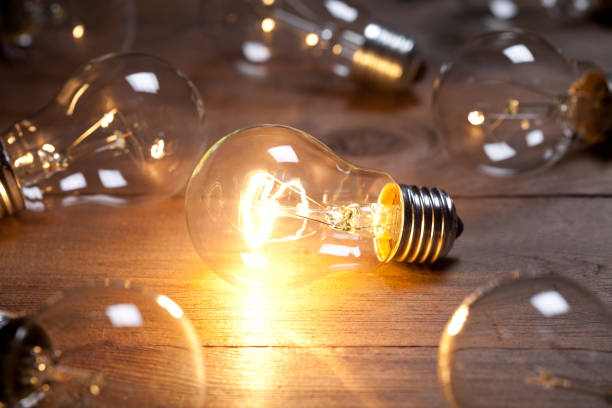 istock Vintage incandescent bulbs on old wooden table 641379294