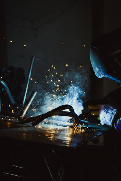 istock Smoke and sparks produced while welding steel pipe 641381862