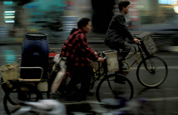a mainroad with a bicycle in the city of Chengdu in the provinz Sichuan in centrall China.