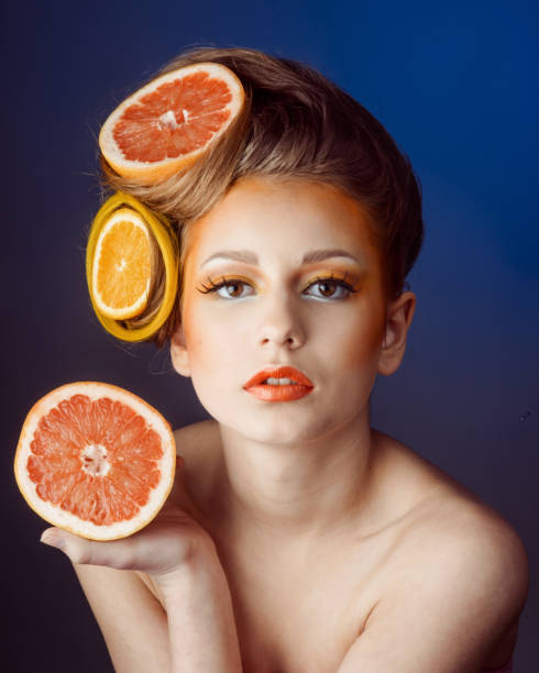 istock woman with fruit in hair 641385862