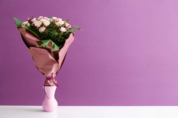 istock Purple roses bouquet in vase 641387576