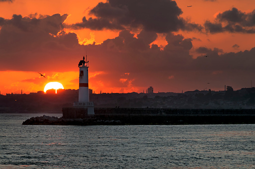 Breakwater with a lighthouse at the Istanbul sea port. On the background the European part of Istanbul.