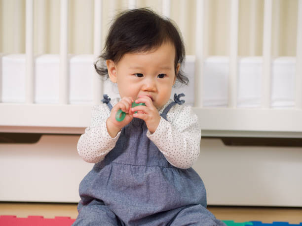 istock baby girl brushing her teeth 641394344