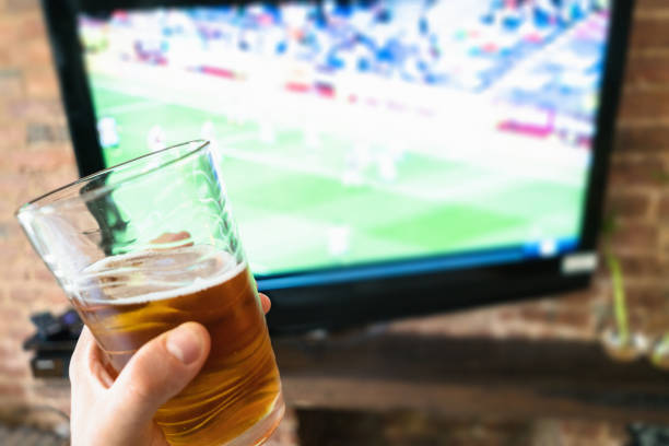 istock drining the beer and watching the tv 641395294