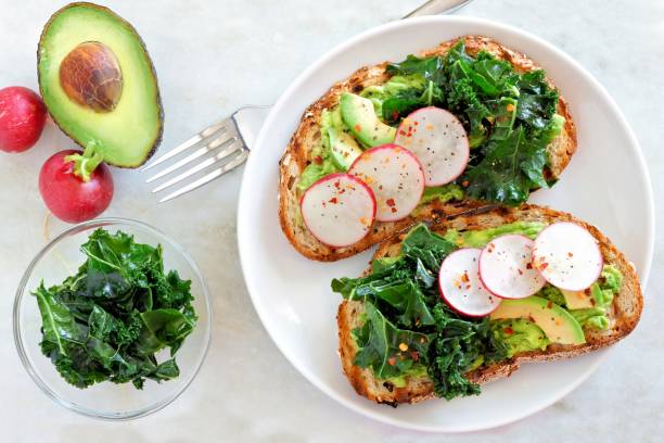 istock Avocado toast with kale and radish, scene over marble 641395654
