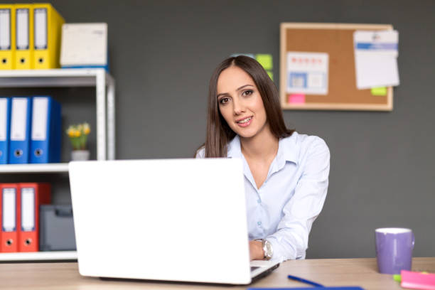 istock Happy businesswoman working on her laptop 641400462