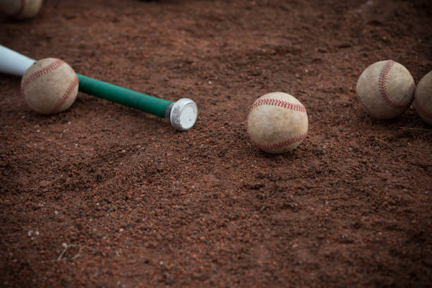 istock baseball bat and balls on floor 641402984