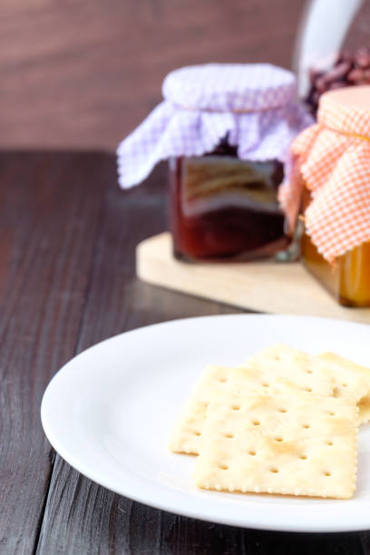 istock Crackers on a plate on wooden background. 641403746