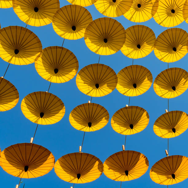 istock Yellow umbrellas on blue sky background 641404794