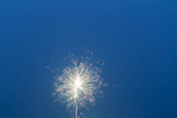 istock fireworks in the blue sky with long trail 641406416