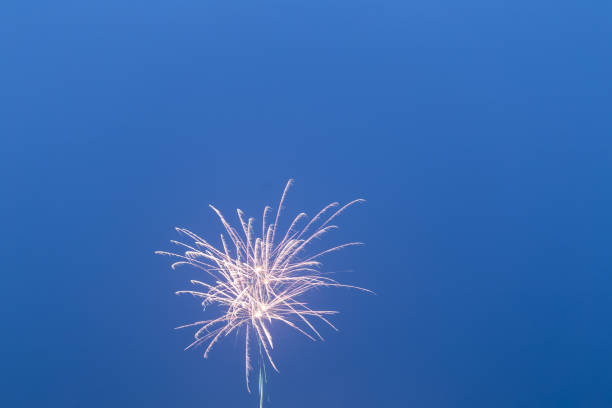 istock fireworks in the blue sky with long trail 641406426