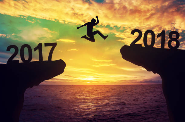 istock A man jump between 2017 and 2018 years. 641406460