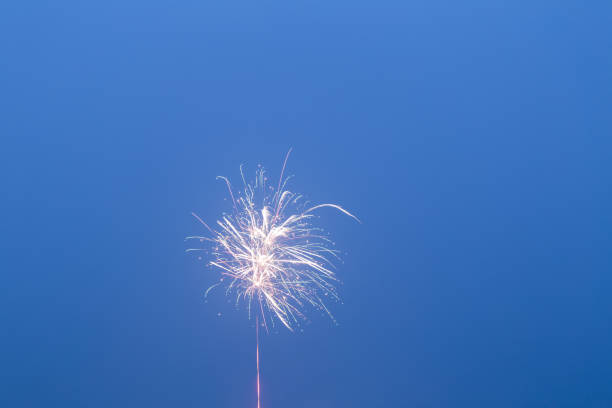 istock fireworks in the blue sky with long trail 641406480