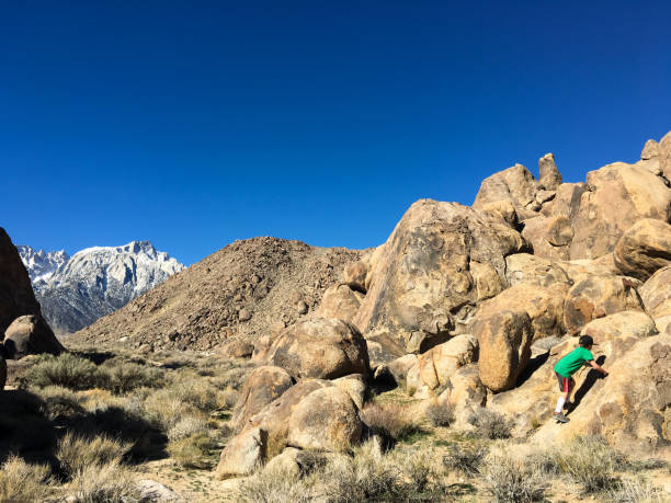 istock Young boy climbing on the rocks in the mountains 641408888