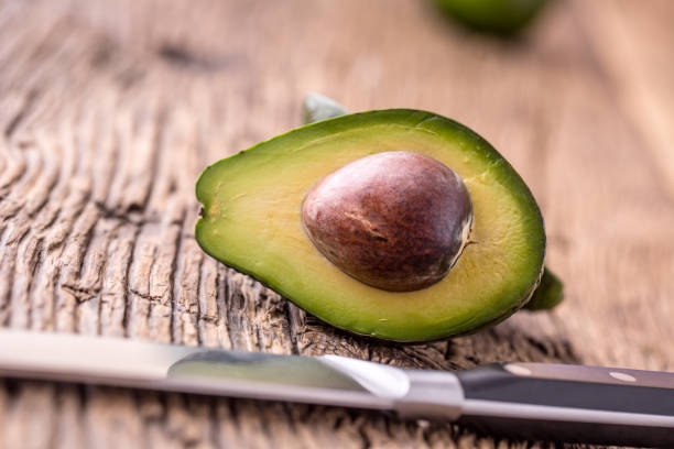 istock Avocado. Cut avocado on a oak wood background table. 641409034