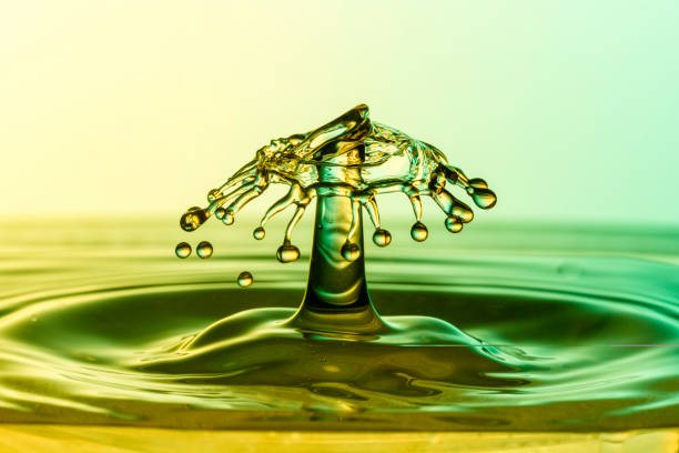 The study of a liquid drop creating shapes stock photo