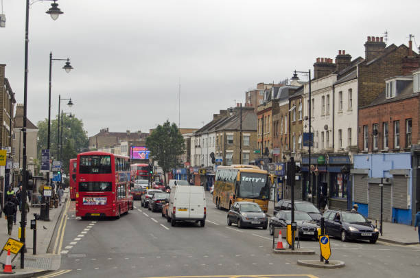 Tottenham High Road, London LONDON, UK - SEPTEMBER 17, 2016:  Busy traffic and pedestrials using the famous Tottenham High Road on a cloudy day in North London. traffic car traffic jam uk stock pictures, royalty-free photos & images