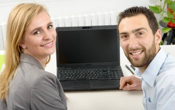 istock attractive man and woman business using laptop computer 641412432