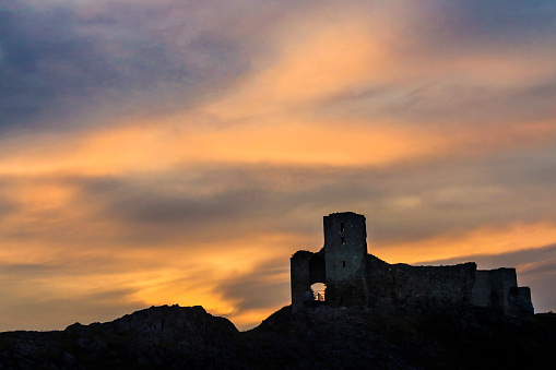 Corfe Castle, United Kingdom - February 13th, 2017 : A distant view of the castle ruins rom the town of Corfe Castle.  Corfe Castle is a village in the county of Dorset. It is the site of a ruined castle of the same name. The village and castle stand over a gap in the Purbeck Hills on the route between Wareham and Swanage.