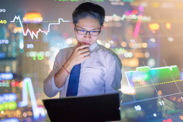 istock Young business man using laptop and digital tablet cityscape background 641415032