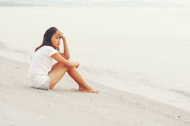 istock Lonely Asian young female on the beach 641415808