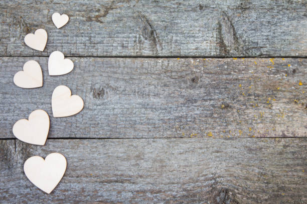 istock Grey rustic wooden beige background with hearts 641416970