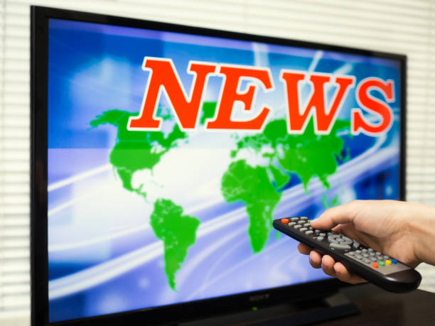 istock Man's hand includes TV news 641417378