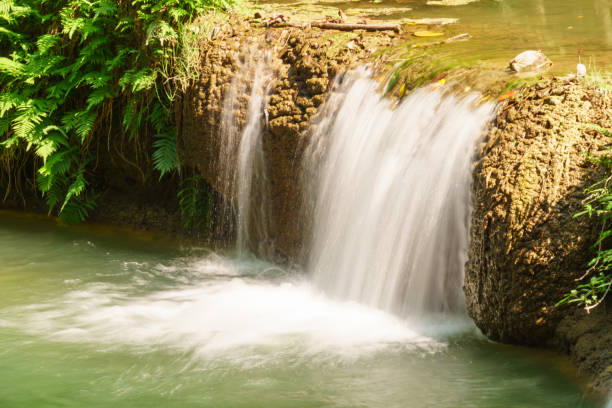 istock Little tropical waterfall in jungle in thailand 641419398
