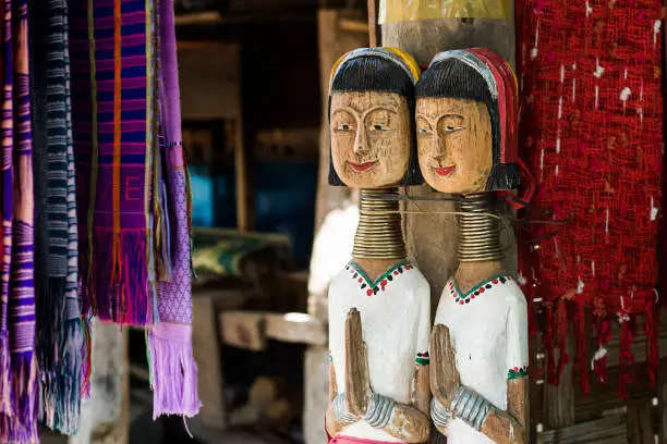 Wooden Dolls of Karen long neck hill tribe, the village in north of Thailand, acting as welcome to visit.